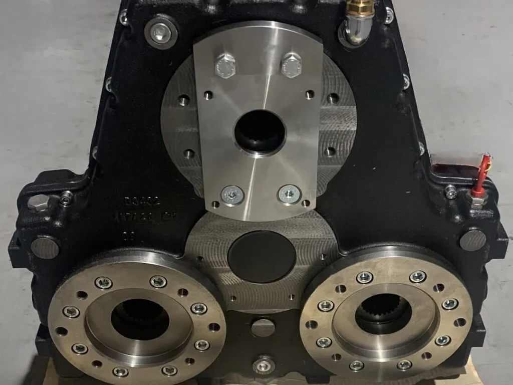 Pump side of a triple pump drive splitter box showing three hydraulic pump mounts